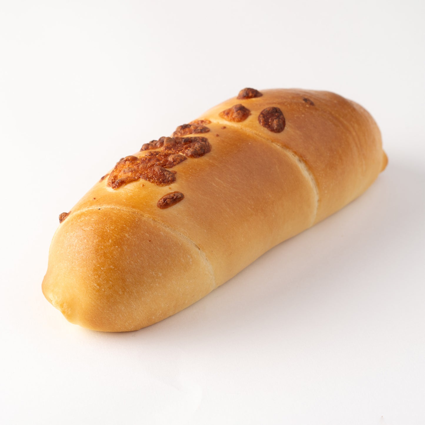 Cachito de queso venezolano recién horneado, relleno de queso derretido y masa suave
