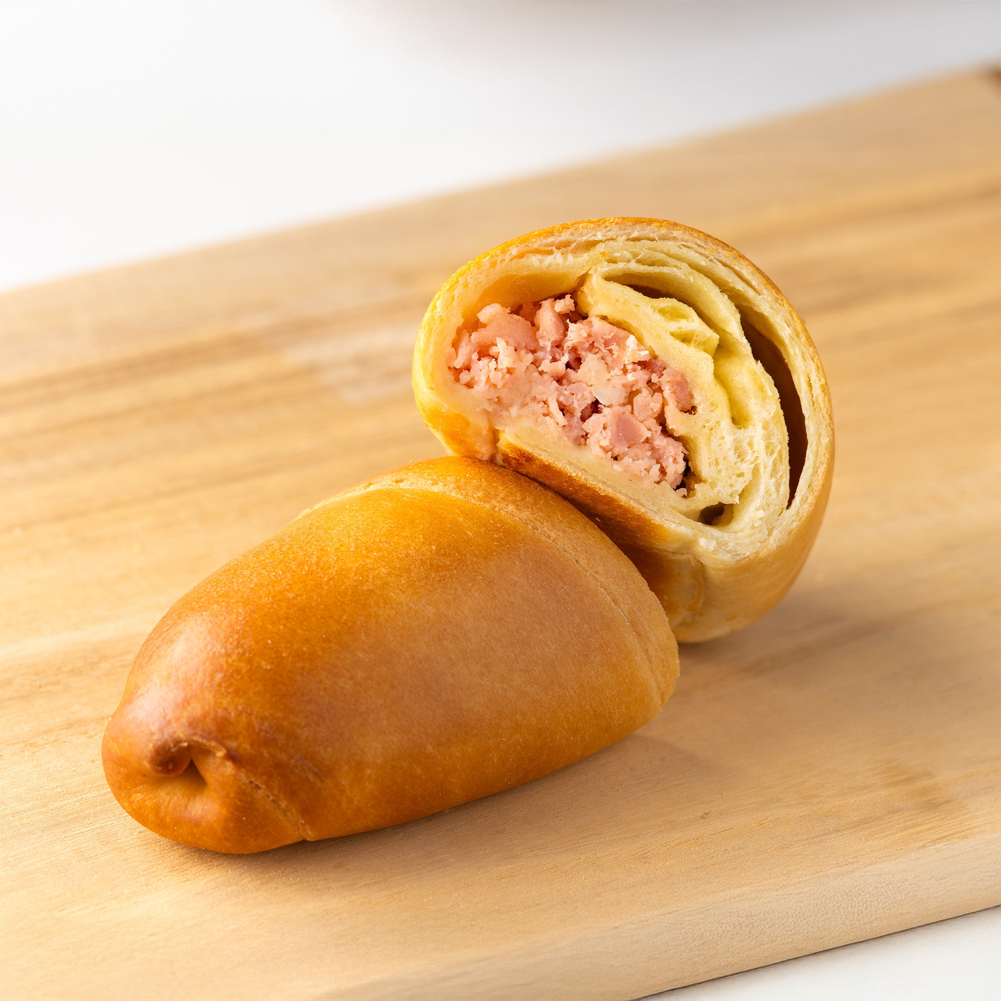 Mini lunch venezolano relleno de jamón y queso derretido, con masa dorada al horno

